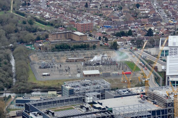 Smoke rises from the North Hyde electrical substation, which caught fire last night, leading to the closure of the Heathrow Airport, in London, Friday March 21, 2025. (Jonathan Brady/PA via AP)