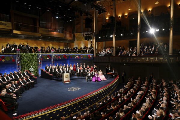 FILE - The Nobel laureates and the royal family of Sweden during the Nobel Prize award ceremony at the Concert Hall in Stockholm, Saturday Dec. 10 2022. The Nobel Foundation has withdrawn its invitation for representatives of Russia, Belarus and Iran to attend this year’s Nobel Prize award ceremonies after the decision to invite them “provoked strong reactions.” Saturday's U-turn came after several Swedish lawmakers said they would boycott this year’s Nobel Prize award ceremonies. (Pontus Lundahl/TT via AP, File)