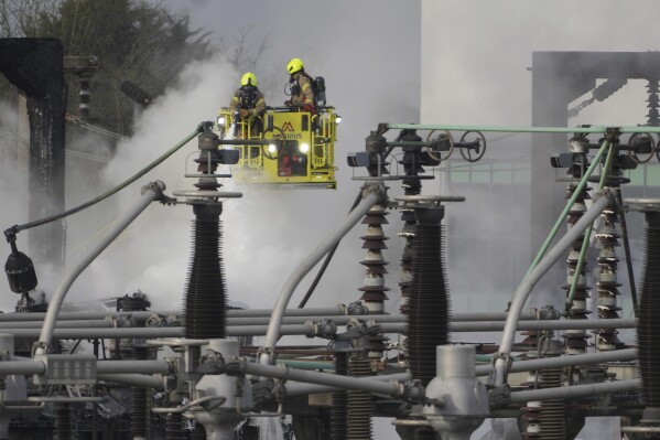 Firefighters extinguish the fire at the North Hyde electrical substation, which caught fire Thursday night and lead to a closure of Heathrow Airport in London, Friday, March 21, 2025.(AP Photo/Kirsty Wigglesworth)