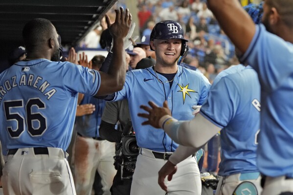 Tampa Bay Rays' Curtis Mead, of Australia, center, celebrates in the dugout after his two-run home run off Detroit Tigers relief pitcher Will Vest during the sixth inning of a baseball game Wednesday, April 24, 2024, in St. Petersburg, Fla. (AP Photo/Chris O'Meara)