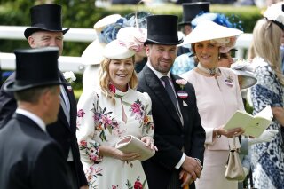 FILE - In this Thursday June 20, 2019 file photo, Peter Phillips and Autumn Phillips attends the third day of the annual Royal Ascot horse race meeting, which is traditionally known as Ladies Day, in Ascot, England. Peter Phillips, the eldest grandson of Queen Elizabeth II, and his wife Autumn are divorcing after 12 years of marriage. The couple said in a statement Tuesday Feb. 11, 2020, that separation was sad but amicable. (AP Photo/Alastair Grant, File)