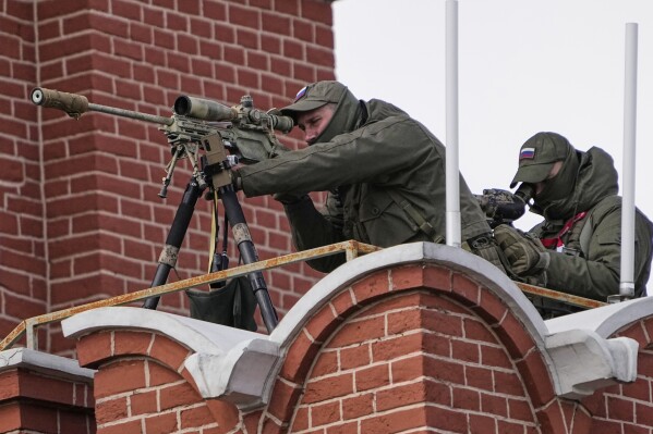 A security service officer aims his sniper rifle securing the area during the Victory Day military parade in Moscow, Russia, Friday, May 9, 2025, during celebrations of the 80th anniversary of the Soviet Union's victory over Nazi Germany in the World War II. (AP Photo/Alexander Zemlianichenko)