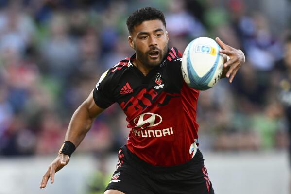Richie Mo'unga of the Christchurch, New Zealand-based Crusaders reaches for the ball during their match against the Otago Highlanders in their Super Rugby Pacific match in Melbourne, Friday, March 3, 2023. (James Ross/AAP Image via AP)