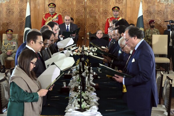 In this photo released by the Pakistan's President Office, President Asif Ali Zardari, center left, administers the oath from federal ministers as Prime Minister Shehbaz Sharif, center right, watches during a ceremony at the Presidential Palace, in Islamabad, Pakistan, Monday, March 11, 2024. The 19-member Cabinet of Pakistan's newly-elected Prime Minister Sharif was sworn in Monday during a brief ceremony. (Pakistan's President Office via AP)