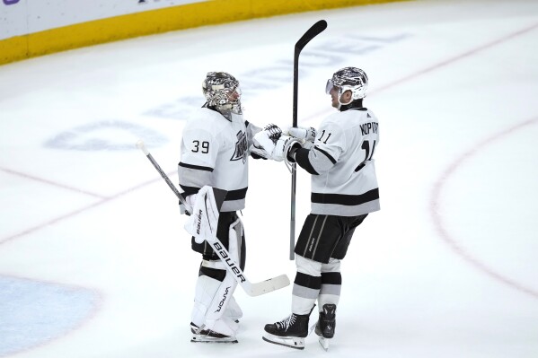 Los Angeles Kings' Anze Kopitar (11) celebrates with goaltender Cam Talbot after Talbot's 5-0 shutout of the Chicago Blackhawks in an NHL hockey game Friday, March 15, 2024, in Chicago. (AP Photo/Charles Rex Arbogast)