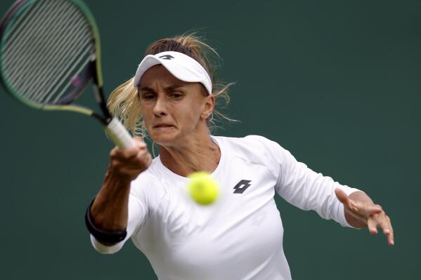 Ukraine's Lesia Tsurenko returns to Britain's Jodie Burrage during a women's singles first round match on day one of the Wimbledon tennis championships in London, Monday, June 27, 2022. (Steve Paston/PA via AP)