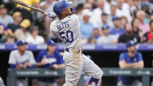 Los Angeles Dodgers' Mookie Betts watches his three-run home run off Colorado Rockies starting pitcher Kyle Freeland during the fourth inning of a baseball game Wednesday, June 28, 2023, in Denver. (AP Photo/David Zalubowski)