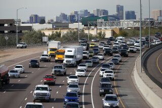 FILE - In this Jan. 24, 2020 file photo, early rush hour traffic rolls along I-10 in Phoenix. Traffic deaths in the U.S. fell for the third straight year in 2019, the government's road safety agency said Thursday, Oct. 1.  The National Highway Traffic Safety Administration says the downward trend is continuing into this year with people driving fewer miles due to the pandemic. (AP Photo/Ross D. Franklin, File)