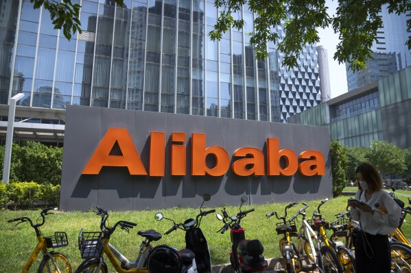 FILE - The logo of Chinese technology firm Alibaba is seen at its office in Beijing on Aug. 10, 2021. China's Alibaba Group says its CEO Eddie Wu will head its core e-commerce business, as the company seeks to drive growth and fend off fast-growing online shopping rivals like Pinduoduo. (AP Photo/Mark Schiefelbein, File)