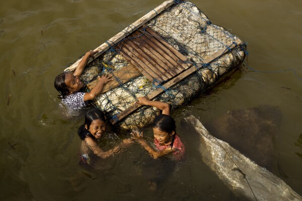 Children play in the water on Kabaena Island, Indonesia, Friday, Nov. 15, 2024. (AP Photo/Yusuf Wahil)