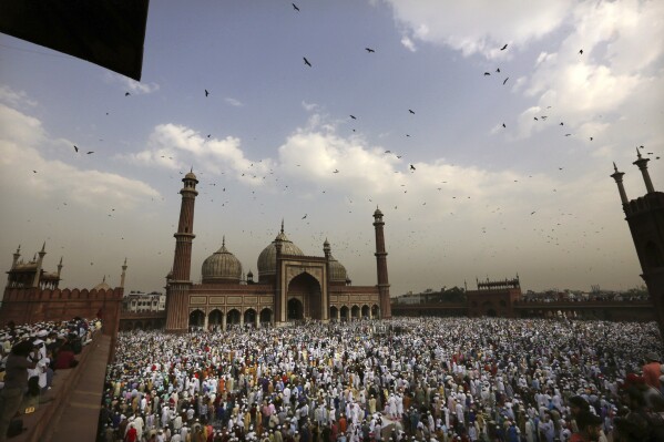 FILE - Muslims hug and greet each other after offering Eid al-Fitr prayers at the Jama Masjid in New Delhi, India, on Wednesday, June 5, 2019. (AP Photo/Manish Swarup, File)