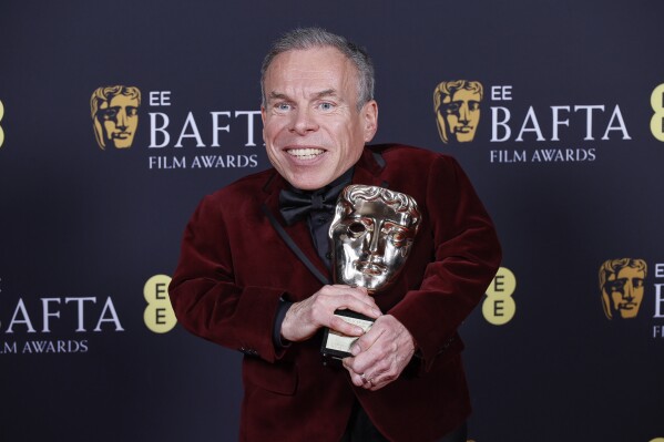Warwick Davis poses with the BAFTA fellowship award at the 78th British Academy Film Awards, BAFTA's, in London, Sunday, Feb. 16, 2025. (Photo by Joel C Ryan/Invision/AP)