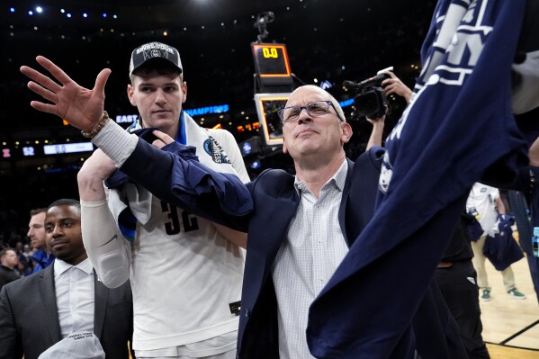 UConn head coach Dan Hurley celebrates with center Donovan Clingan, left, after defeating Illinois following an Elite 8 college basketball game in the men's NCAA Tournament, Saturday, March 30, 2024, in Boston. (AP Photo/Michael Dwyer)
