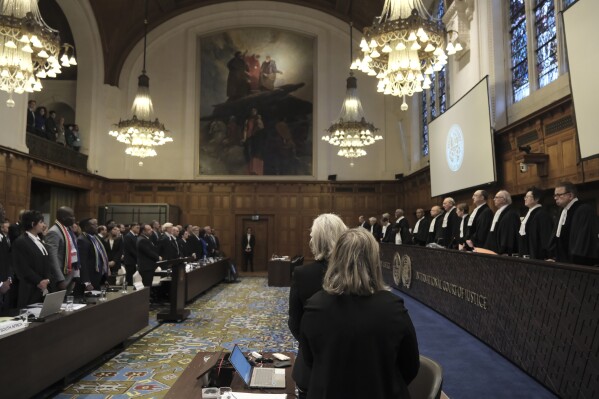 Judges and parties stand up during a hearing at the International Court of Justice in The Hague, Netherlands, Friday, Jan. 12, 2024. The United Nations' top court opened hearings Thursday into South Africa's allegation that Israel's war with Hamas amounts to genocide against Palestinians, a claim that Israel strongly denies. (AP Photo/Patrick Post)