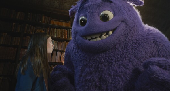 This image released by Paramount Pictures shows Cailey Fleming, left, with Blue, voiced by Steve Carell, in a scene from "IF." (Paramount Pictures via AP)