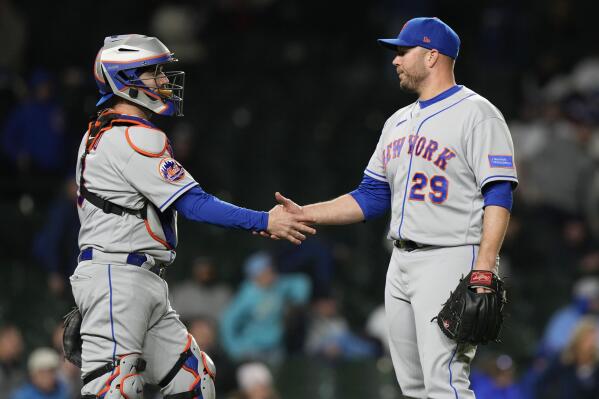 New York Mets catcher Francisco Alvarez, left, celebrates with relief pitcher Tommy Hunter after the Mets defeated the Chicago Cubs 10-1 in a baseball game in Chicago, Thursday, May 25, 2023. (AP Photo/Nam Y. Huh)