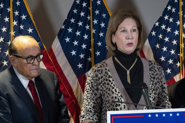 Sidney Powell, right, speaks next to former Mayor of New York Rudy Giuliani, as members of President Donald Trump's legal team, during a news conference at the Republican National Committee headquarters, Thursday Nov. 19, 2020, in Washington. (AP Photo/Jacquelyn Martin)