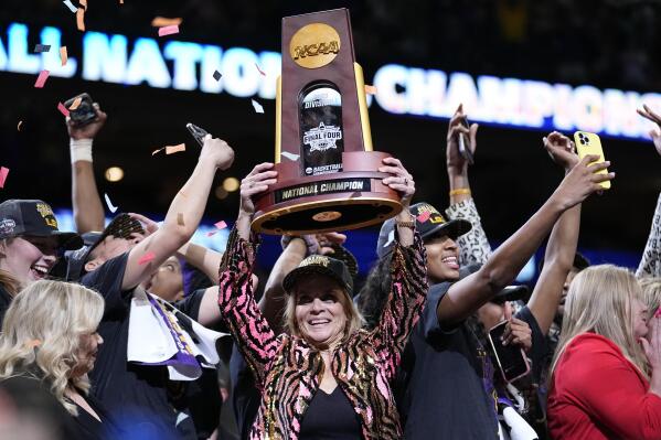 LSU head coach Kim Mulkey holds the winning trophy after the NCAA Women's Final Four championship basketball game against Iowa Sunday, April 2, 2023, in Dallas. LSU won 102-85 to win the championship. (AP Photo/Tony Gutierrez)