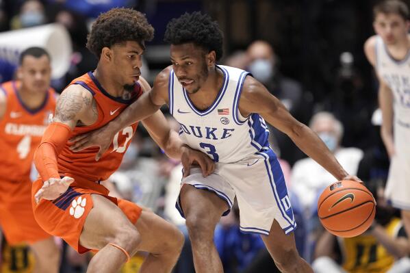 Clemson guard David Collins (13) defends against Duke guard Jeremy Roach (3) during the first half of an NCAA college basketball game in Durham, N.C., Tuesday, Jan. 25, 2022. (AP Photo/Gerry Broome)