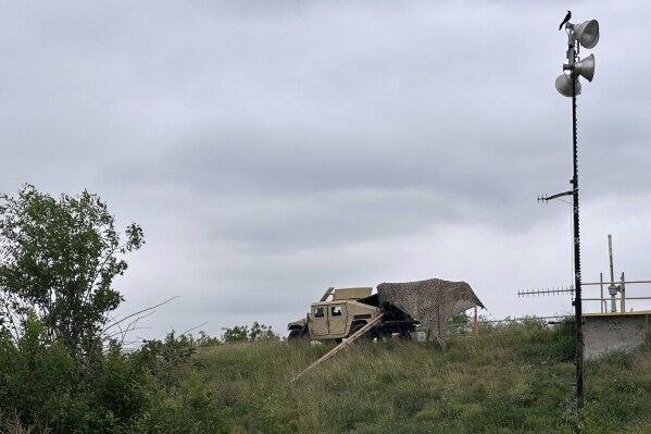 Members of the National Guard patrol a road near a federal border wall Tuesday evening, March 19, 2024, in Hidalgo, Texas. . A divided Supreme Court on Tuesday allowed Texas to begin enforcing a law that gives police broad powers to arrest migrants suspected of crossing the border illegally while a legal battle over the measure plays out. (AP Photo/Valerie Gonzalez)