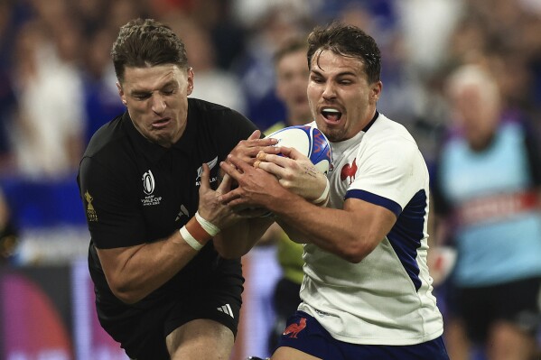 New Zealand's Beauden Barrett, left, and ,France's Antoine Dupont challenge for the ball during the Rugby World Cup Pool A match between France and New Zealand in Saint-Denis, north of Paris, Friday, Sept, 8, 2023. (AP Photo/Aurelien Morissard)