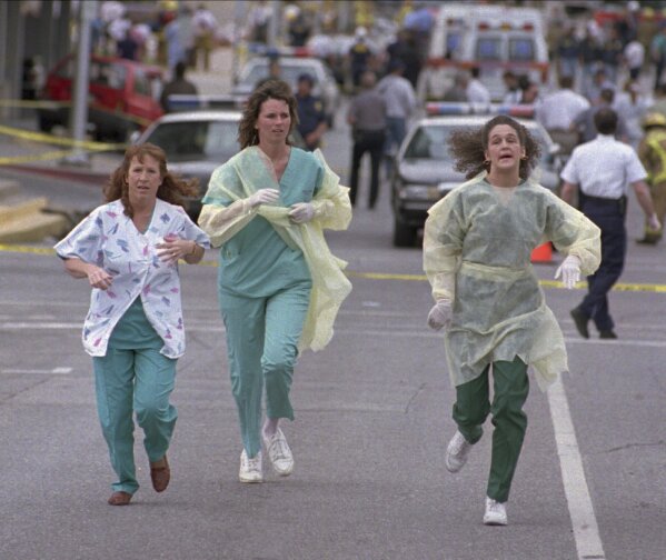 Medical assistants Janet Froehlich, Wilma Jackson and Kerri Albright run from the Alfred P. Murrah Federal Building after being told another bomb device had been found on April 19, 1995, in Oklahoma City. (AP Photo/David J. Phillip, File)