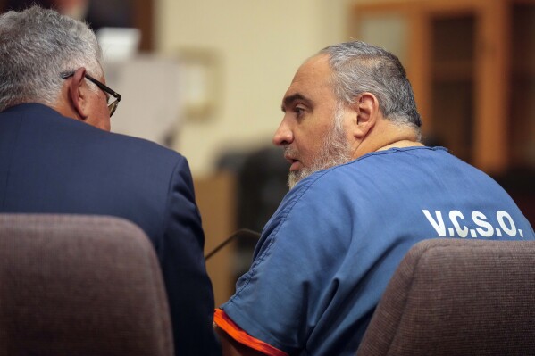 Attorney Ron Bamieh, left, listens to his client, Loay Abdelfattah Alnaji, a professor of computer science at Moorpark College, during an appearance in Ventura County Superior Court in connection with the death of Paul Kessler in Ventura, Calif., Friday, Nov. 17, 2023. California authorities said Friday they have not ruled out that a hate crime was committed in the death of a pro-Israel demonstrator following a confrontation with Alnaji but so far the evidence only supports the charges of involuntary manslaughter and battery. (AP Photo/Damian Dovarganes)