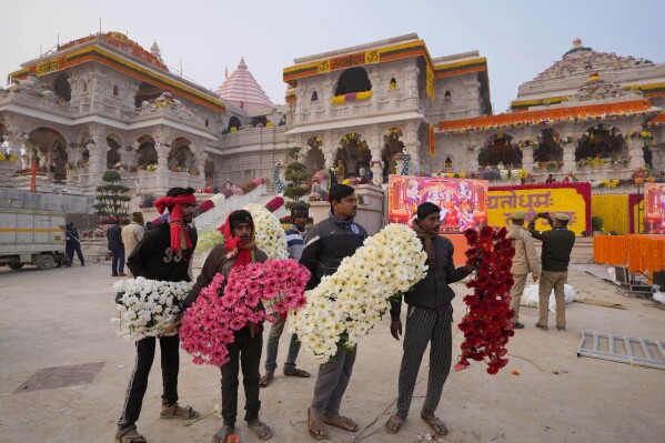 Workers decorate a temple dedicated to Hindu deity Lord Ram with flowers the day before the temple's grand opening in Ayodhya, India, Sunday, Jan. 21, 2024. (AP Photo/Rajesh Kumar Singh)