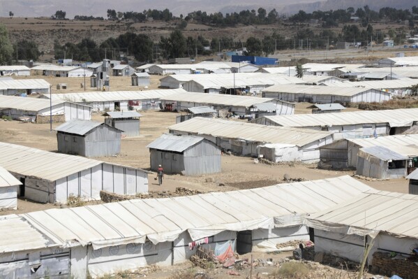 A man walks through the Sebacare internally displaced persons (IDPs) camp, on the outskirts of Mekele, Tigray region, Ethiopia, Wednesday, Feb. 12, 2025. (AP Photo/Alexander Mamo)