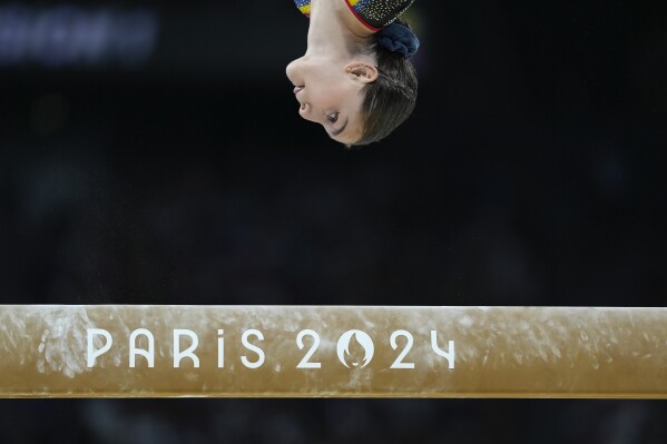 Lilia Cosman, of Romania, competes on the balance beam during a women's artistic gymnastics qualification round at the 2024 Summer Olympics, Sunday, July 28, 2024, in Paris, France. (AP Photo/Abbie Parr)