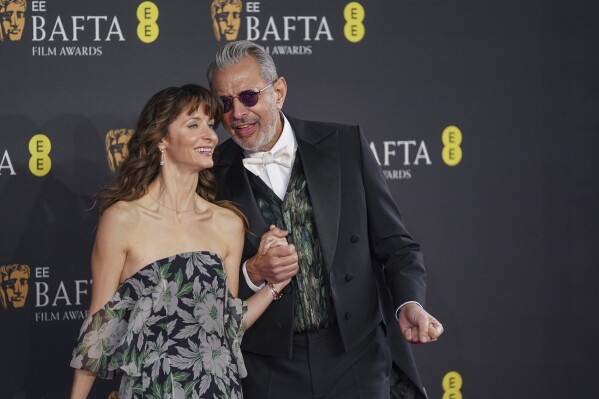 Emilie Livingston, left, and Jeff Goldblum pose for photographers upon arrival at the 78th British Academy Film Awards, BAFTA's, in London, Sunday, Feb. 16, 2025. (Photo by Alberto Pezzali/Invision/AP)