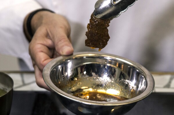 FILE - In this Wednesday, Jan. 16, 2019 photo, chef Amir Ilan prepares a lab-grown steak during a presentation by the company Aleph Farms, in Jaffa, Israel. On Wednesday, Jan. 17, 2024, Aleph Farms received the green light from Israeli health officials to produce and sell the world's first steaks made from cultivated beef cells, not the entire animal. The move follows approval of lab-grown chicken in the U.S. in 2023. (AP Photo/Tsafrir Abayov, File)