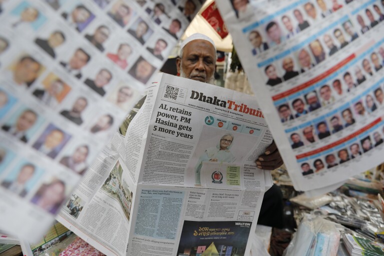FILE - A man reads a Bangladeshi newspaper that has the news of Prime Minister Sheikh Hasina's election victory in Dhaka, Bangladesh, Monday, Jan.8, 2024. (AP Photo/Mahmud Hossain Opu, File)