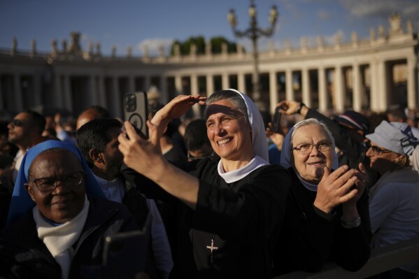 Nuns react after the announcement of the newly elected Pope Leo XIV at the Vatican, Thursday, May 8, 2025. (AP Photo/Francisco Seco)