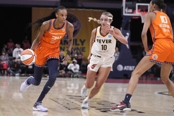 Connecticut Sun's DeWanna Bonner (24) goes to the basket against Indiana Fever's Lexie Hull (10) during the first half of a WNBA basketball game Friday, Aug. 4, 2023, in Indianapolis. (AP Photo/Darron Cummings)
