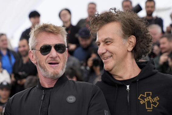 Sean Penn, left, and director Jean-Stephane Sauvaire pose for photographers at the photo call for the film 'Black Flies' at the 76th international film festival, Cannes, southern France, Friday, May 19, 2023. (Photo by Scott Garfitt/Invision/AP)