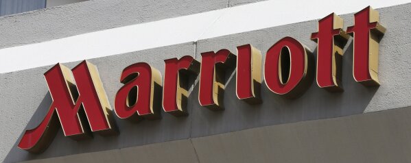 
              FILE - This March 23, 2016, file photo, shows a sign at a Marriott Hotel in Richmond, Va. Marriott is pushing more heavily into home-sharing, confident that its combination of luxury properties and loyalty points can lure travelers away from rivals like Airbnb. (AP Photo/Steve Helber, File)
            