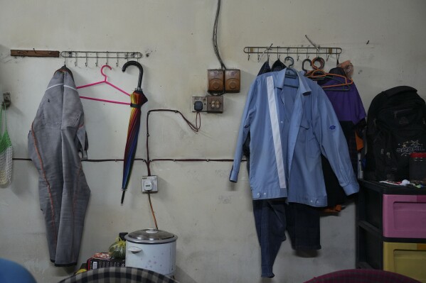 A uniform used by a migrant worker at Kawaguchi Manufacturing is seen hanging in a dormitory in Klang, Malaysia, Friday, Jan. 24, 2025. (AP Photo/Azneal Ishak)