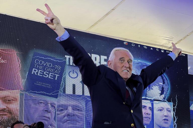 Conservative political consultant Roger Stone gestures victory to the cheering crowd during the ReAwaken America Tour at Cornerstone Church, in Batavia, N.Y., Friday, Aug. 12, 2022. (AP Photo/Carolyn Kaster)