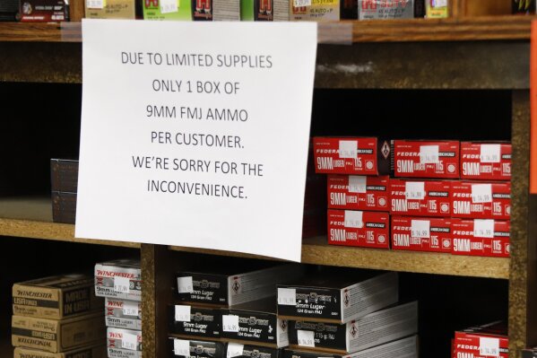 Signs point out quantity limits on certain types of ammunition after Dukes Sport Shop reopened, Wednesday, March 25, 2020, in New Castle, Pa. under the new conditions specified for gun stores. The store had closed last week when Pennsylvania Gov. Tom Wolf ordered a shut down of non-essential businesses to slow the spread of the coronavirus. (AP Photo/Keith Srakocic)