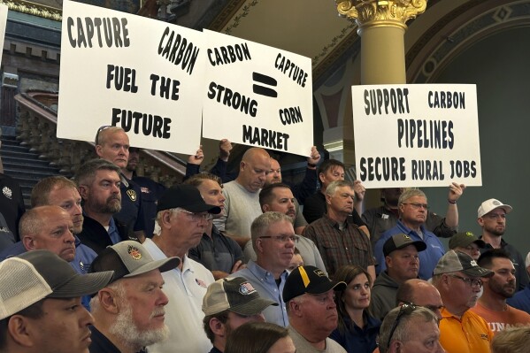 Iowans that rely on the state's ethanol industry rally at the statehouse in Des Moines on Friday, May 9, 2025 to voice support for a massive carbon-capture pipeline project routed across several Midwest states. (AP Photo/Hannah Fingerhut)