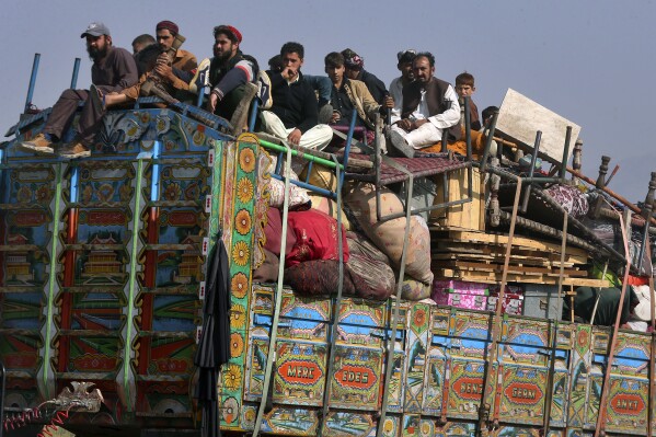 FILE - Afghan families onboard a truck head toward a border crossing point in Torkham, Pakistan, Tuesday, Oct. 31, 2023. For more than 1 million Afghans who fled war and poverty to Pakistan, these are uncertain times. Since Pakistan announced a crackdown on migrants last year, some 600,000 have been deported and at least a million remain in Pakistan in hiding. They've retreated from public view, abandoning their jobs and rarely leaving their neighborhoods out of fear they could be next. It's harder for them to earn money, rent accommodation, buy food or get medical help because they run the risk of getting caught by police or being reported to authorities by Pakistanis.(AP Photo/Muhammad Sajjad, File)