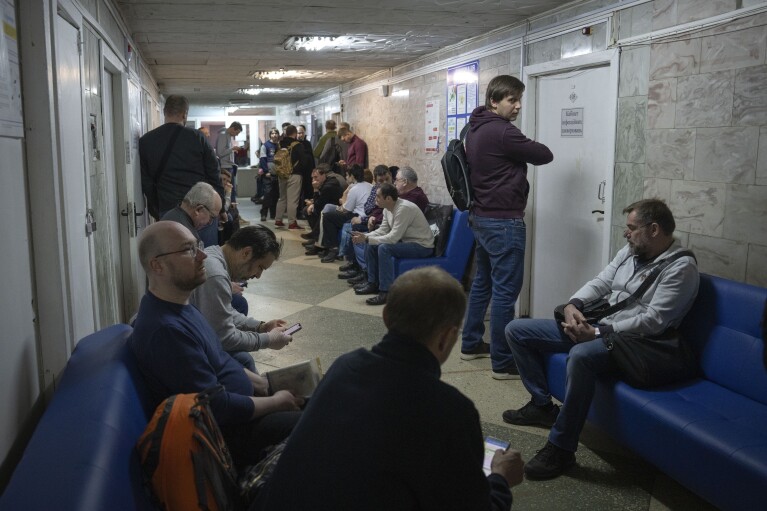 Recruits wait for their turn to pass medical examination in a city hospital in Kyiv, Ukraine, Thursday, Feb. 8, 2024.(AP Photo/Efrem Lukatsky)