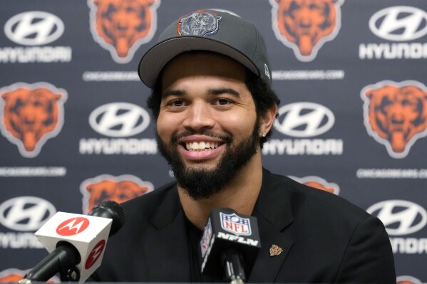 Chicago Bears No. 1 draft pick quarterback Caleb Williams smiles as he listens to reporters during an NFL football news conference in Lake Forest, Ill., Friday, April 26, 2024. (AP Photo/Nam Y. Huh)