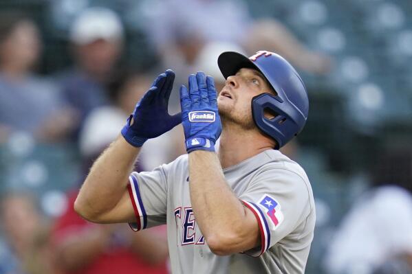 Texas Rangers' John Hicks looks skyward as he crosses home on his solo home run against the Seattle Mariners in the third inning of a baseball game Saturday, July 3, 2021, in Seattle. (AP Photo/Elaine Thompson)