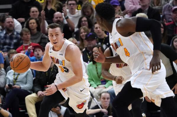 Miami Heat forward Duncan Robinson (55) looks to pass the ball to guard Victor Oladipo (4) during the first half of the team's NBA basketball game against the Utah Jazz, Saturday, Dec. 31, 2022, in Salt Lake City. (AP Photo/George Frey)