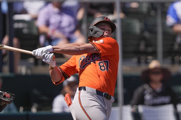 Baltimore Orioles Jackson Holliday (87) swings at a pitch in the first inning of a spring training baseball game against the Atlanta Braves in North Port, Fla., Monday, Feb. 26, 2024. (AP Photo/Gerald Herbert)
