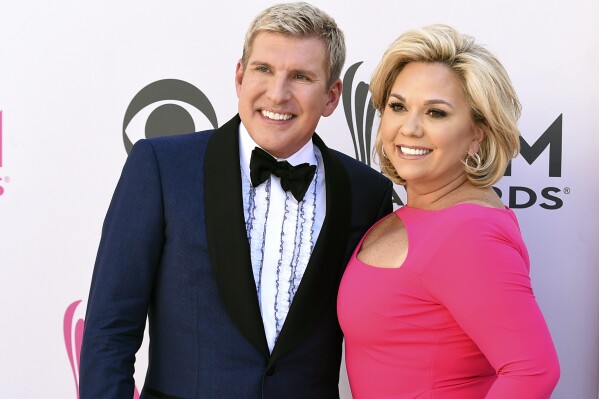 Julie Chrisley, right, and her husband Todd Chrisley pose for photos at the 52nd annual Academy of Country Music Awards April 2, 2017, in Las Vegas. (Jordan Strauss/Invision/AP, File)