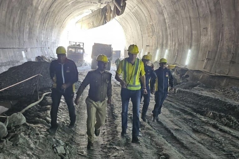 This photo provided by Uttarakhand State Disaster Response Force (SDRF) shows rescuers and others inside a collapsed road tunnel where 40 workers were trapped in northern in Uttarakhand state, India, Tuesday, Nov.14, 2023. ( SDRF via AP)