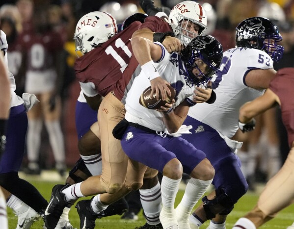 TCU quarterback Chandler Morris (4) scrambles and gets loose from Iowa State defensive end Joey Petersen (52) during the first half of an NCAA college football game, Saturday, Oct. 7, 2023, in Ames, Iowa. (AP Photo/Matthew Putney.)